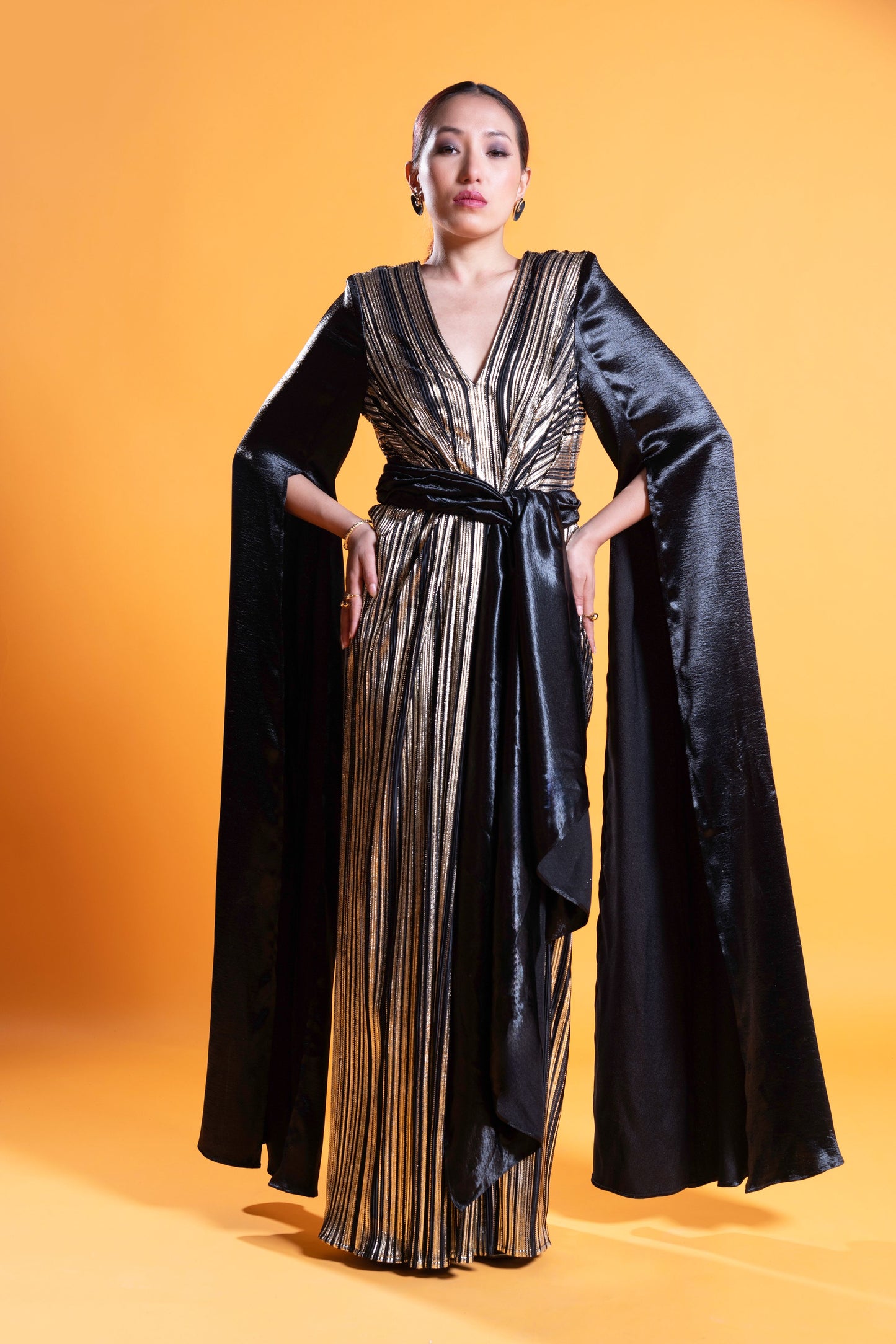 Black and gold long sleeve draped evening gown