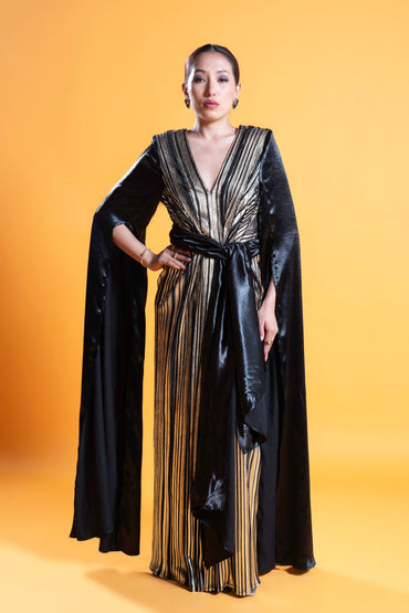 Black and gold long sleeve draped evening gown