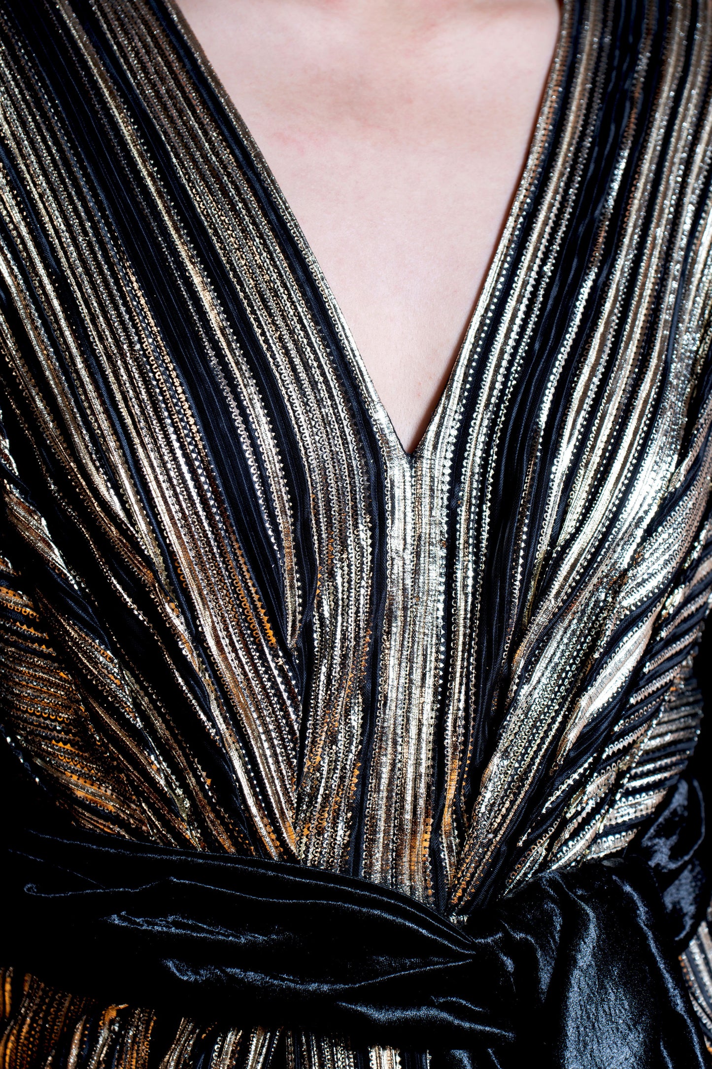 Black and gold long sleeve draped evening gown