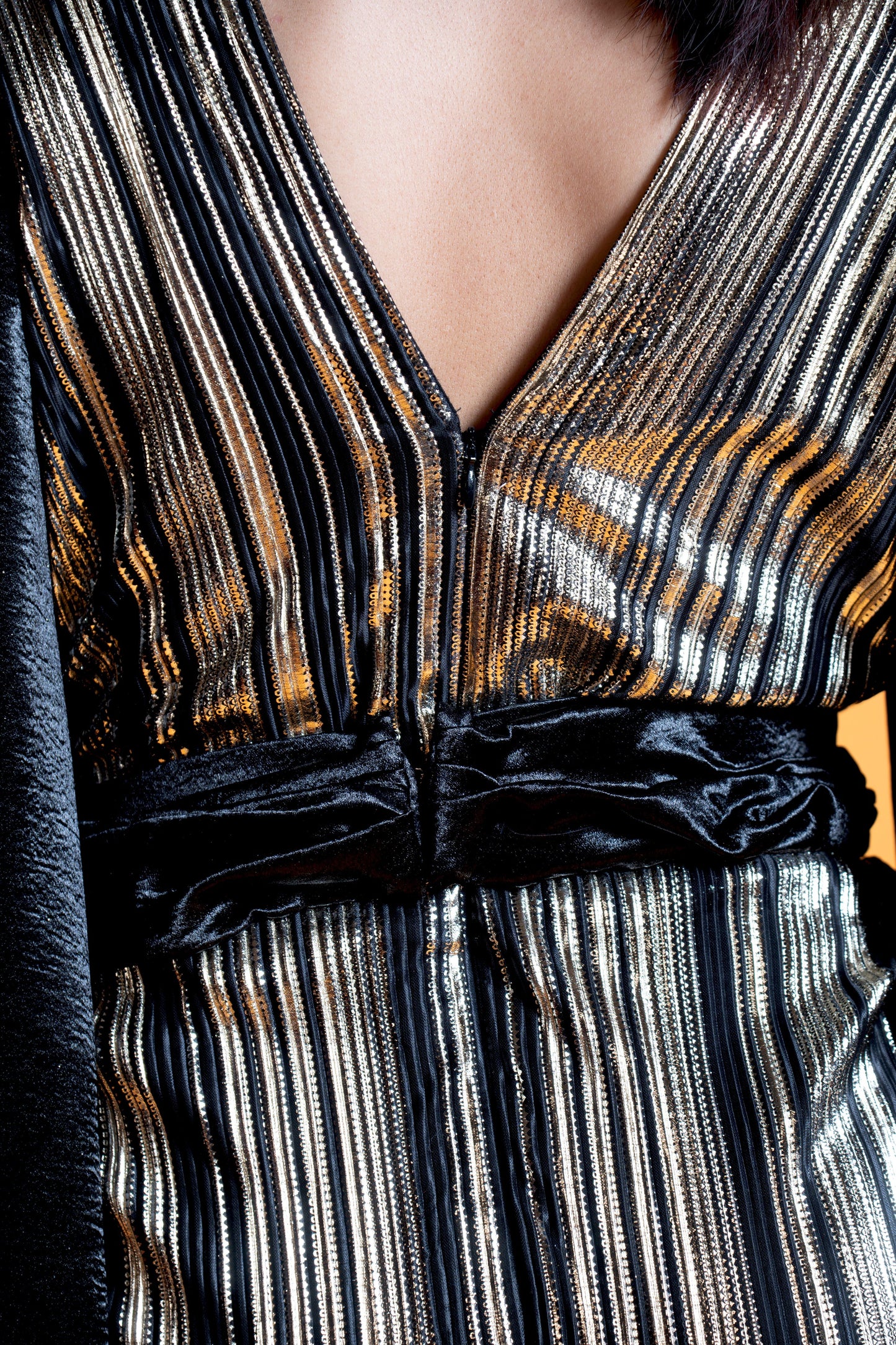 Black and gold long sleeve draped evening gown