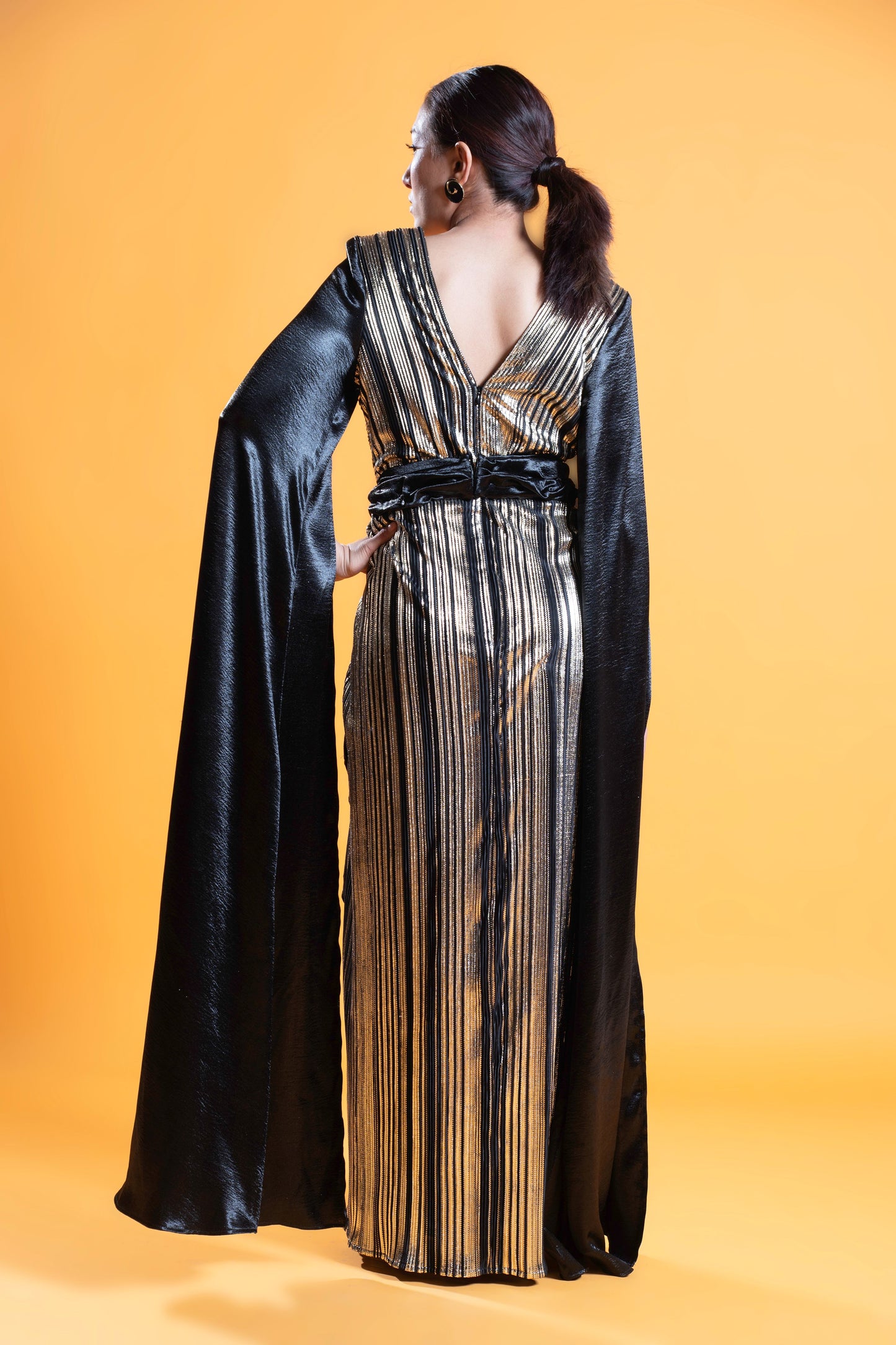 Black and gold long sleeve draped evening gown