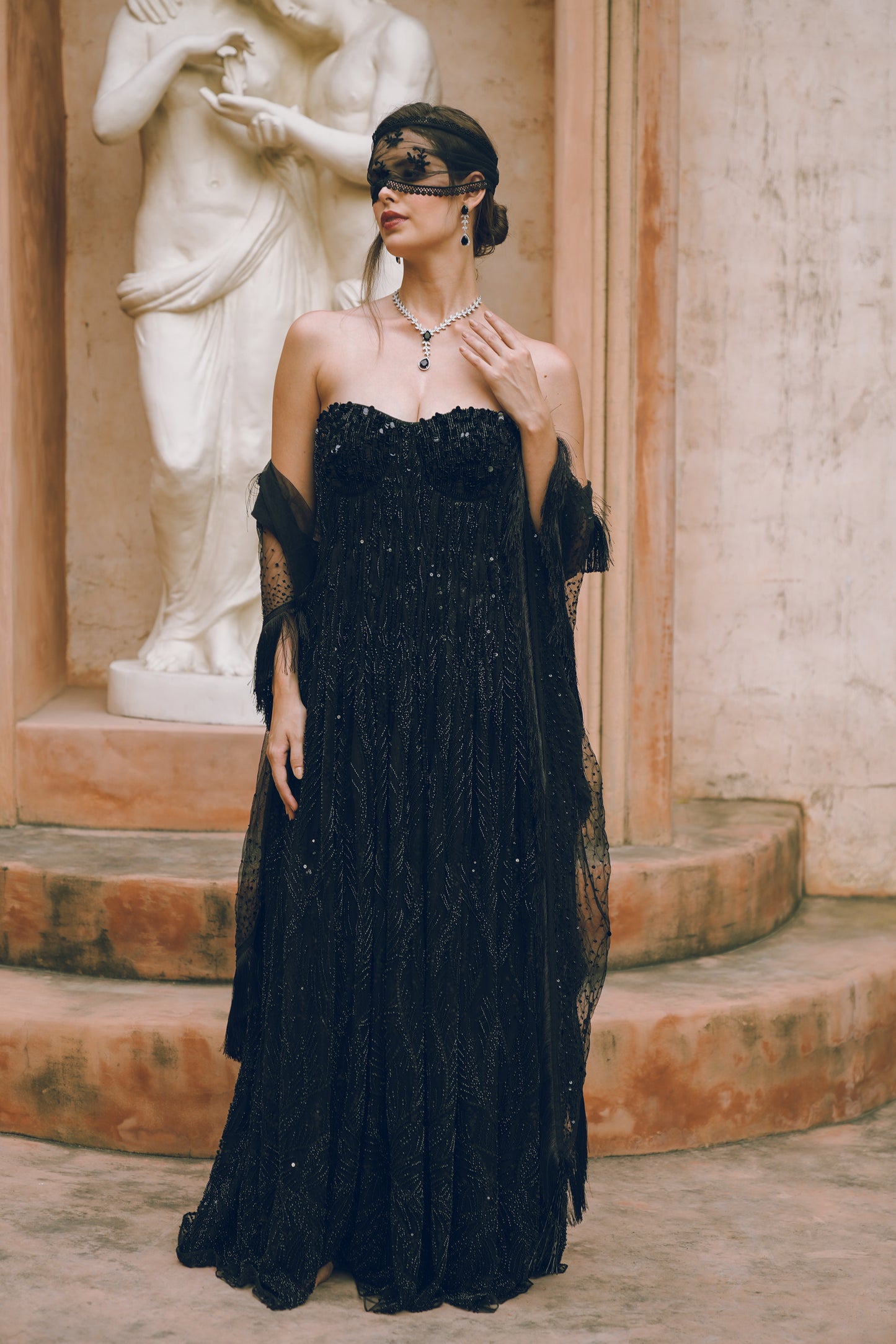 Black embroidered draped evening gown