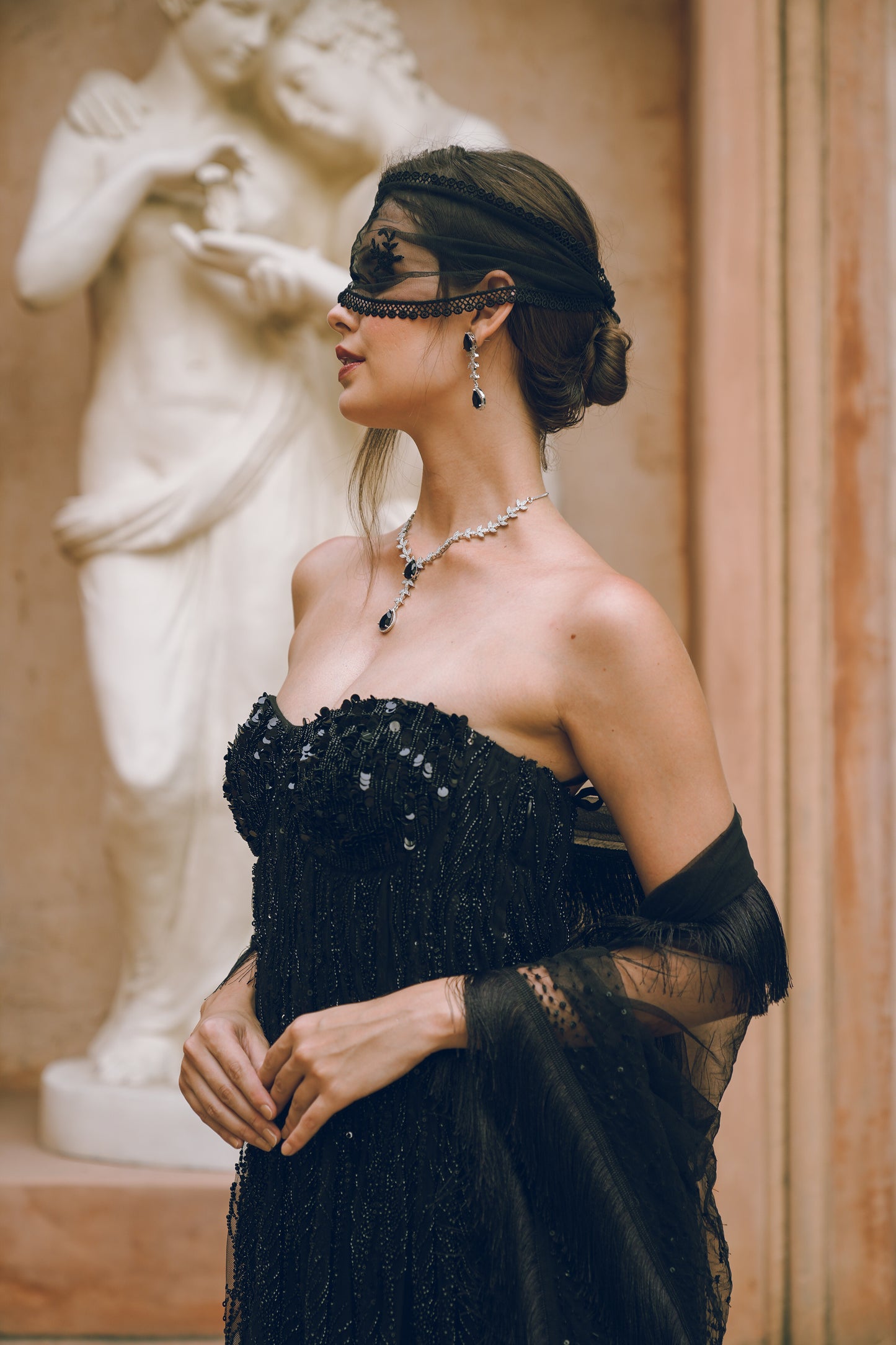 Black embroidered draped evening gown
